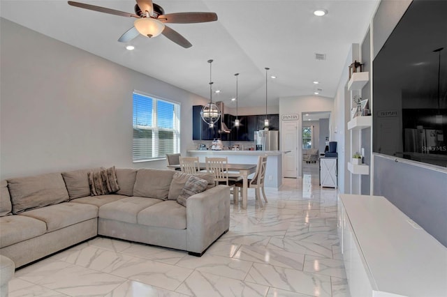 tiled living room featuring ceiling fan