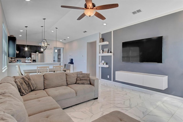 tiled living room featuring ceiling fan and built in shelves