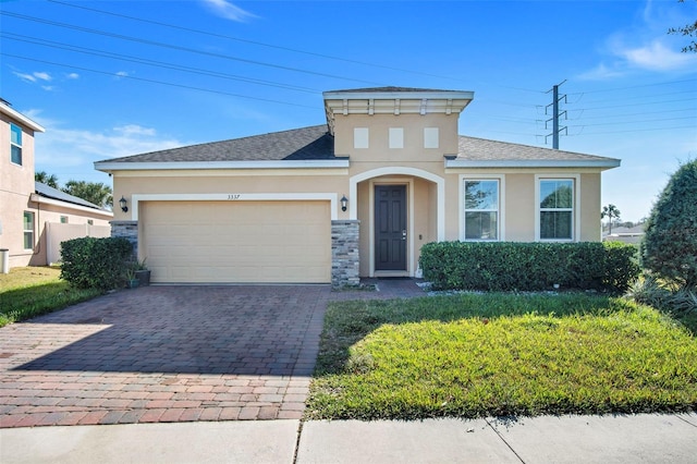 view of front facade with a garage and a front lawn