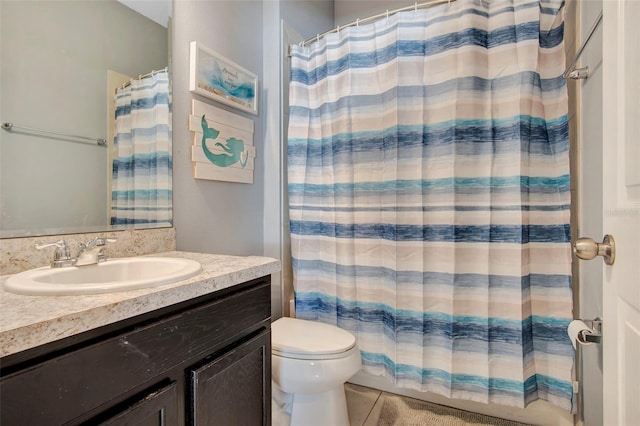 bathroom featuring oversized vanity, toilet, and tile floors