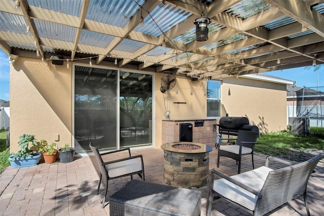 view of patio / terrace featuring an outdoor fire pit, a pergola, and area for grilling