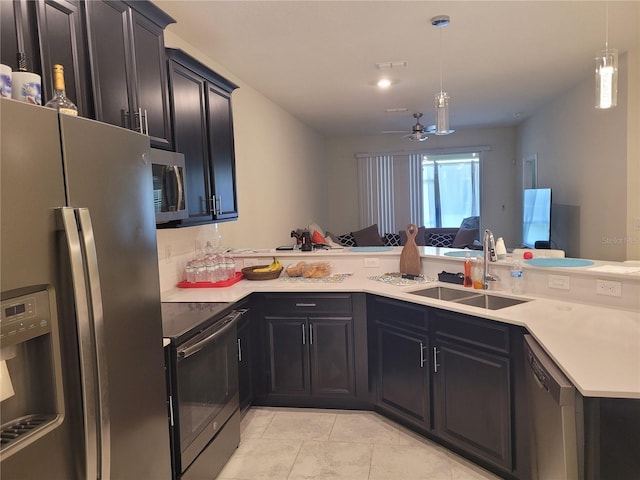 kitchen featuring appliances with stainless steel finishes, light tile floors, kitchen peninsula, ceiling fan, and sink