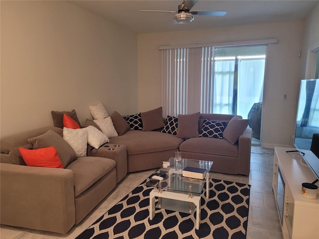 living room featuring light tile floors, ceiling fan, and a wealth of natural light