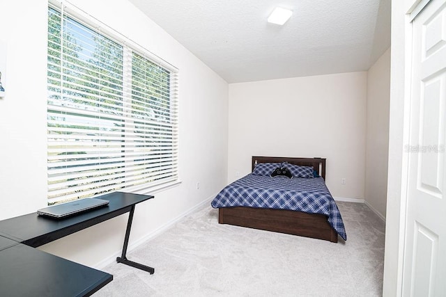 carpeted bedroom with a textured ceiling