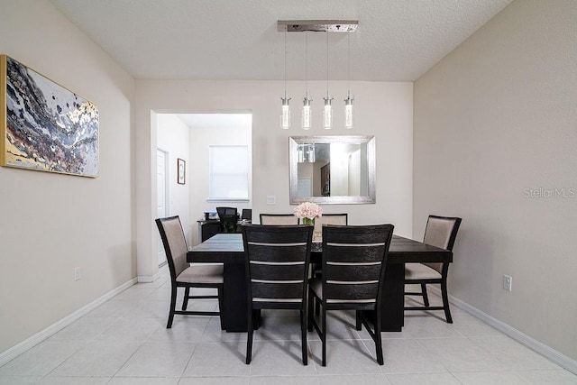 dining area with tile patterned floors and a textured ceiling