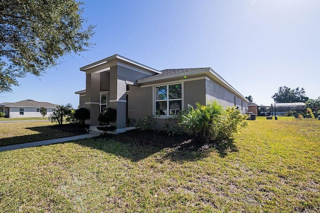 view of side of property with a lawn