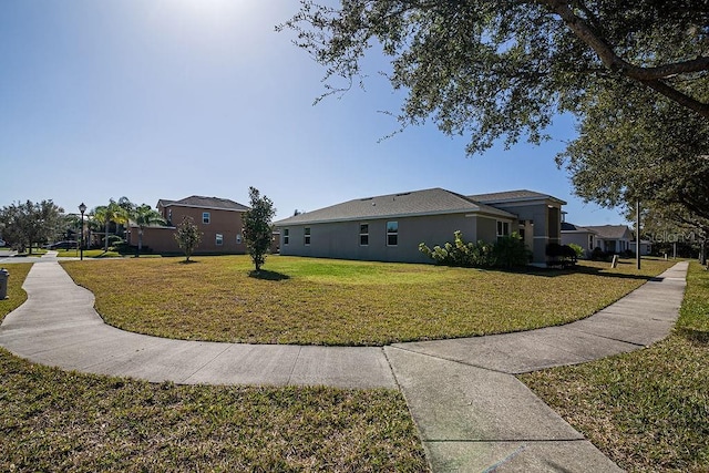 view of side of home with a lawn