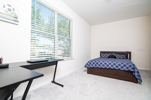 carpeted bedroom featuring a textured ceiling