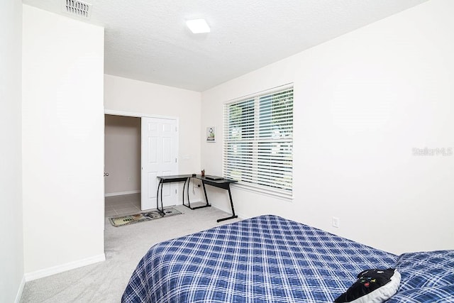 carpeted bedroom with a textured ceiling