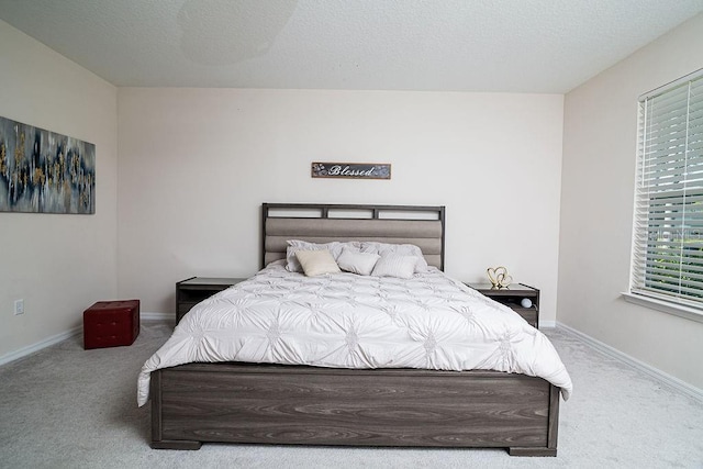 bedroom with carpet floors and a textured ceiling