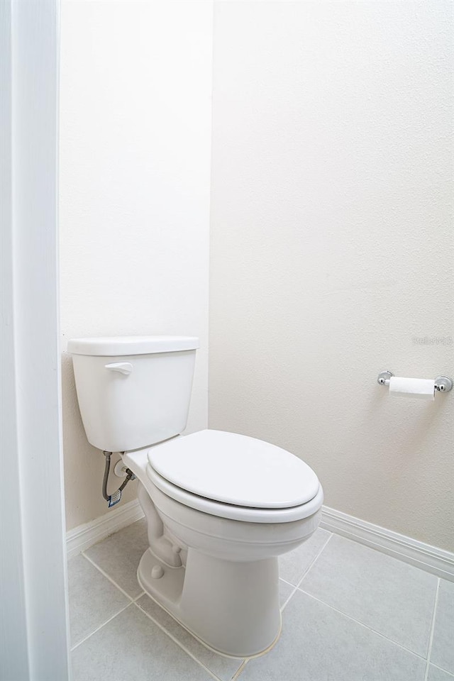 bathroom featuring tile patterned floors and toilet