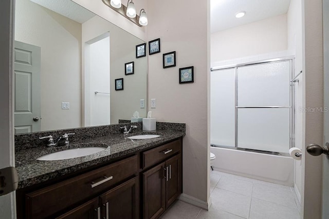 full bathroom featuring shower / bath combination with glass door, tile patterned flooring, vanity, and toilet