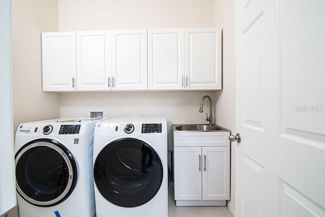 clothes washing area featuring cabinets, independent washer and dryer, light tile patterned floors, and sink