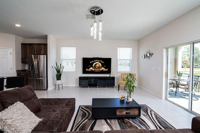 living room with plenty of natural light and light tile patterned floors