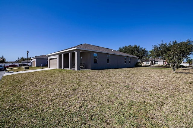 view of side of home with a garage and a lawn