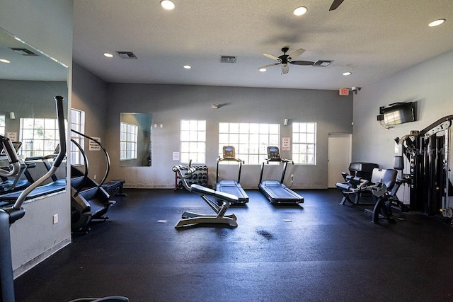 gym featuring ceiling fan and a textured ceiling