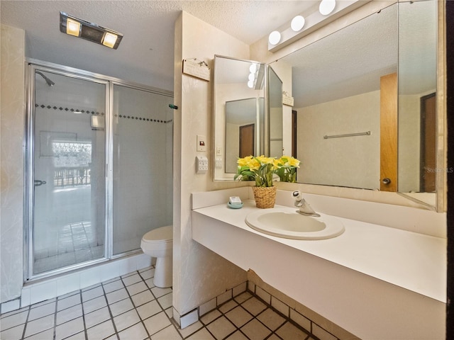 bathroom with toilet, walk in shower, tile patterned floors, vanity, and a textured ceiling