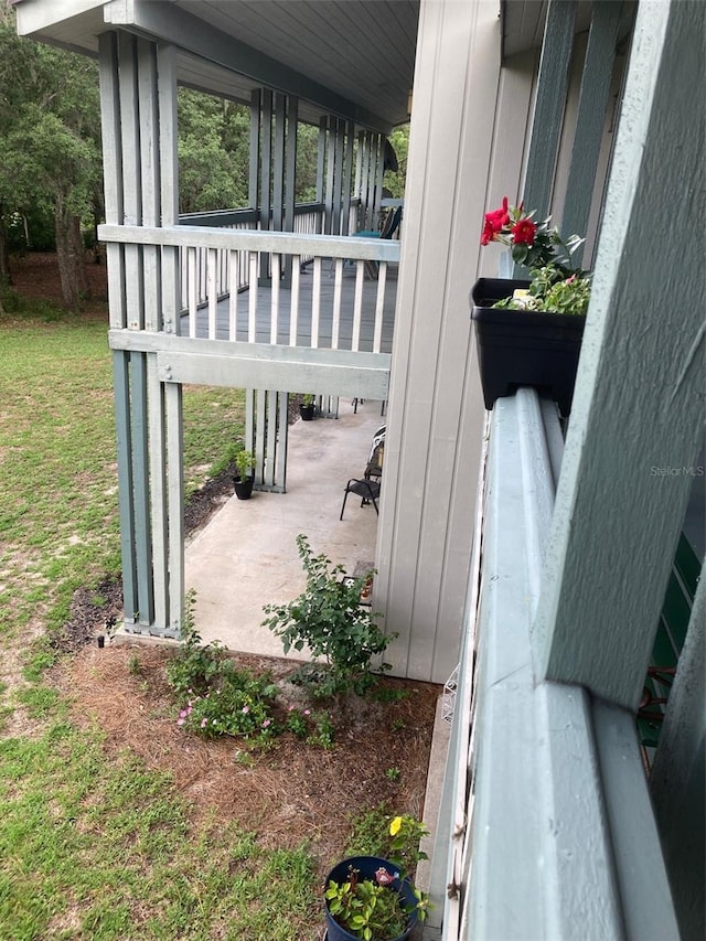 exterior space featuring a porch and a lawn