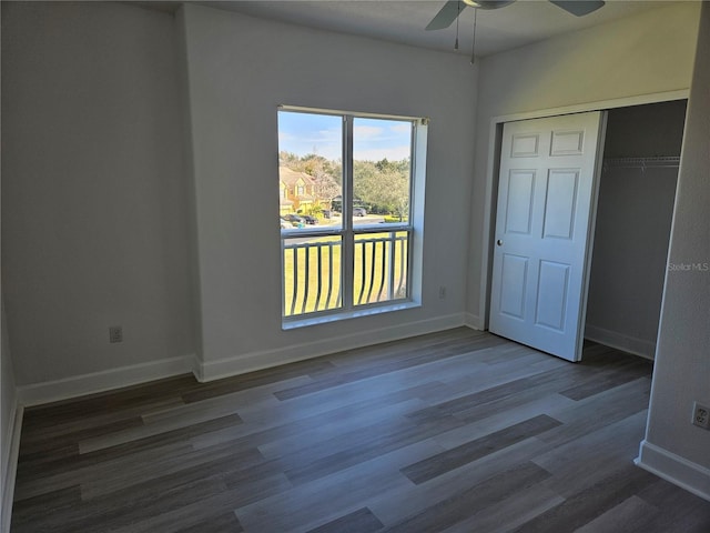 unfurnished bedroom featuring a closet, ceiling fan, and dark hardwood / wood-style floors