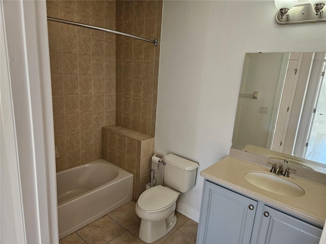 full bathroom with toilet, tile floors, tiled shower / bath combo, and vanity