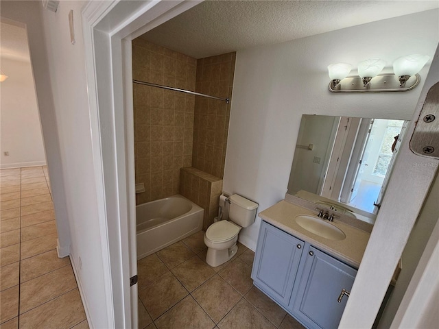 full bathroom featuring tiled shower / bath combo, toilet, tile flooring, a textured ceiling, and large vanity