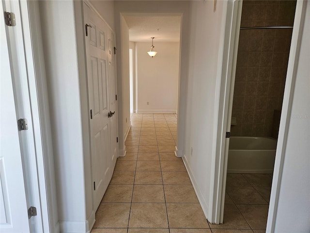 hallway featuring light tile flooring