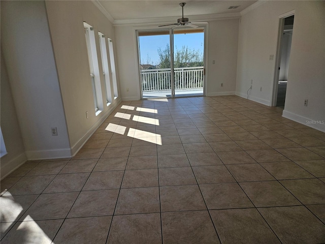 unfurnished room featuring dark tile flooring, crown molding, and ceiling fan