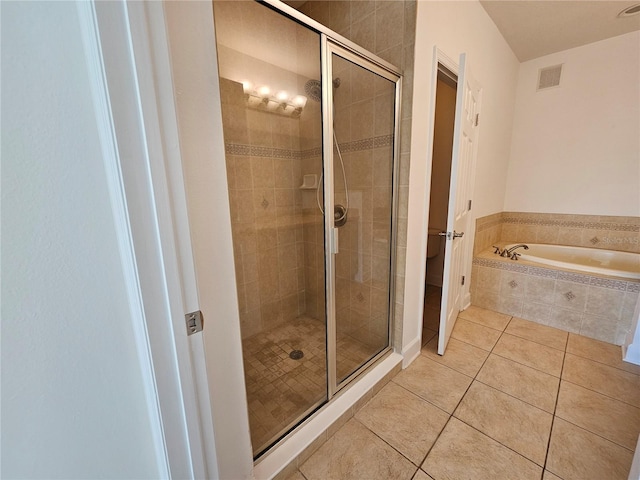 bathroom with tile flooring and independent shower and bath