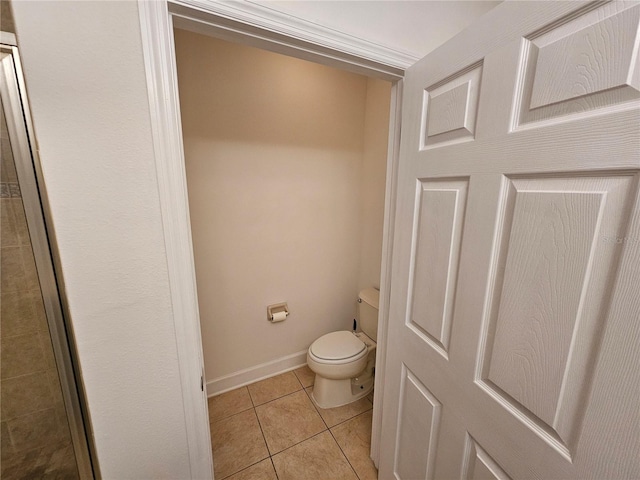 bathroom with toilet and tile flooring