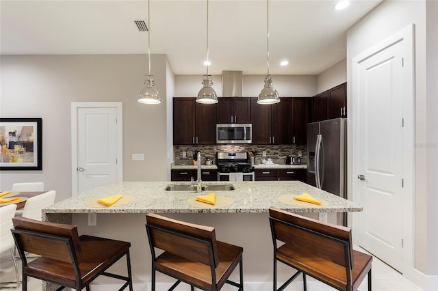 kitchen featuring tasteful backsplash, sink, appliances with stainless steel finishes, and dark brown cabinetry