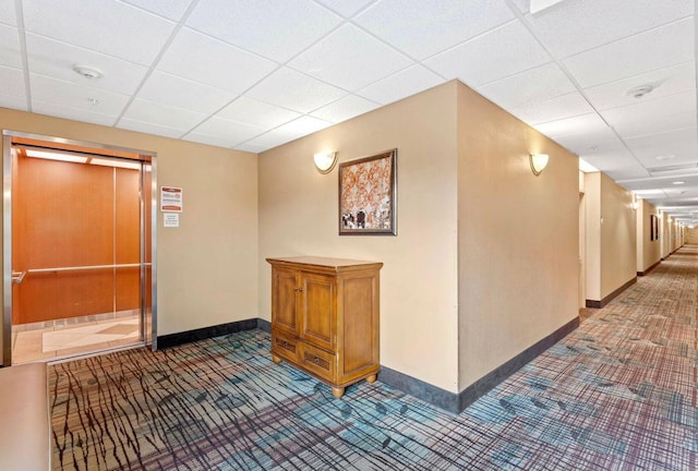 hallway featuring a drop ceiling