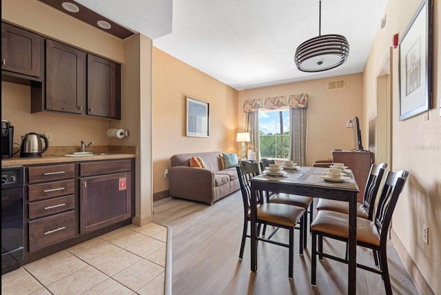 dining space with sink and light hardwood / wood-style flooring