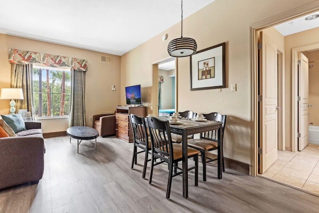 dining space with light hardwood / wood-style flooring