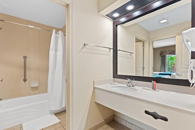 bathroom featuring tile patterned floors, sink, and shower / tub combo with curtain