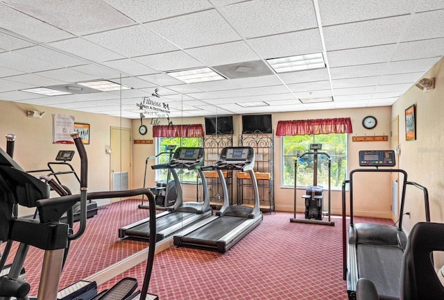 exercise room with carpet and a drop ceiling