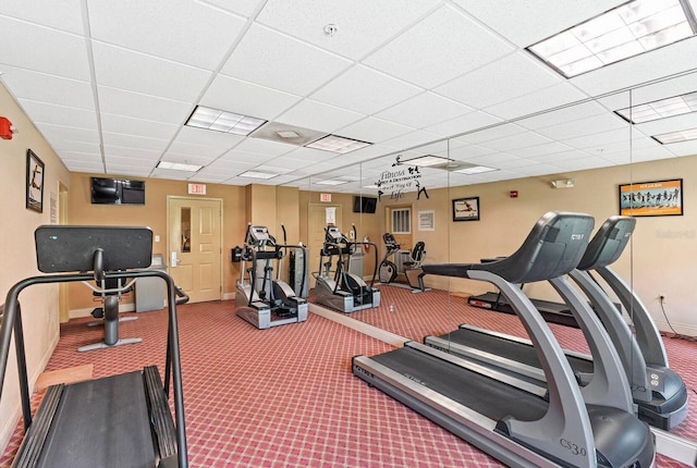 workout area with a paneled ceiling and carpet floors