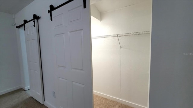 spacious closet featuring dark carpet