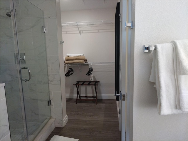 bathroom with hardwood / wood-style floors and a shower with door