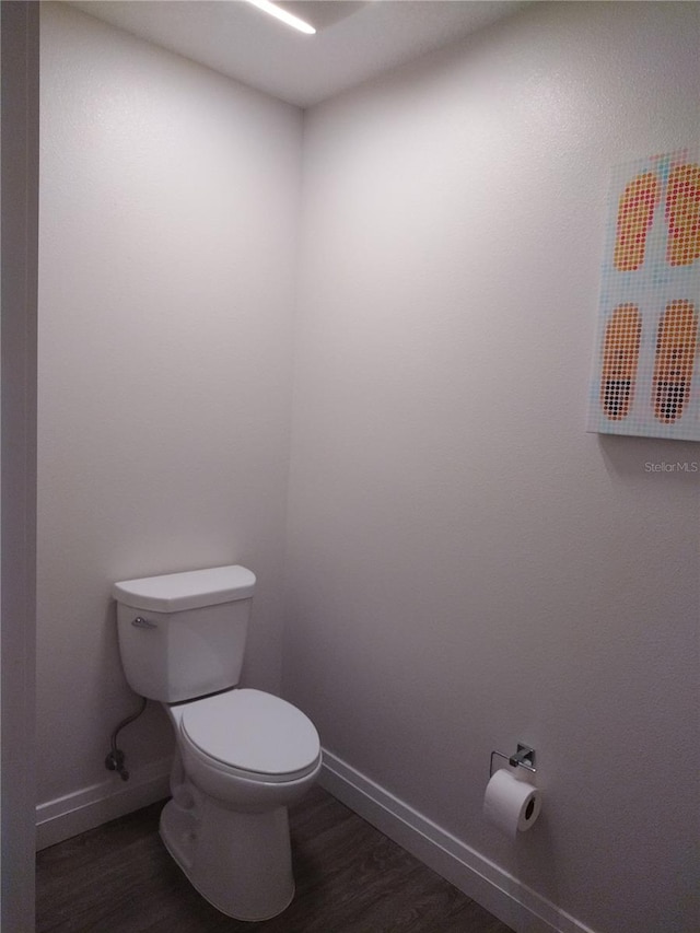 bathroom featuring hardwood / wood-style floors and toilet