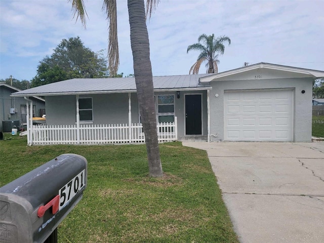 ranch-style house featuring covered porch, a front lawn, and a garage