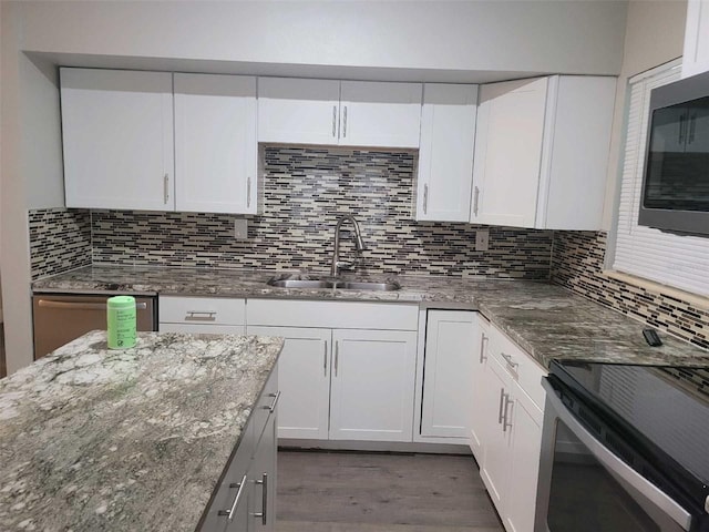 kitchen featuring backsplash, dark hardwood / wood-style flooring, and white cabinetry