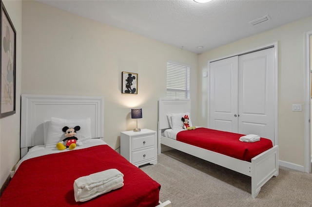 bedroom featuring light carpet and a closet