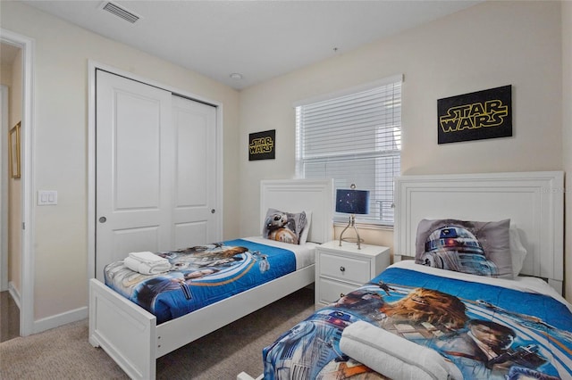 carpeted bedroom with a closet