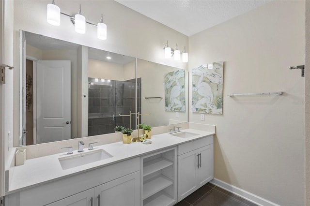 bathroom with large vanity, a textured ceiling, tile flooring, dual sinks, and an enclosed shower