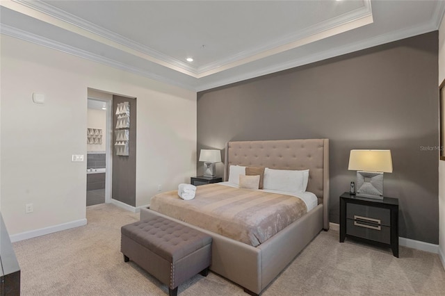 bedroom featuring ensuite bath, crown molding, a raised ceiling, and light colored carpet