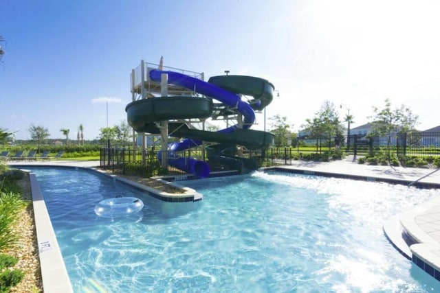 view of swimming pool with a water slide