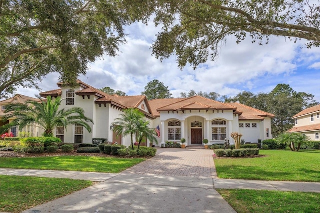 mediterranean / spanish-style house with a front yard