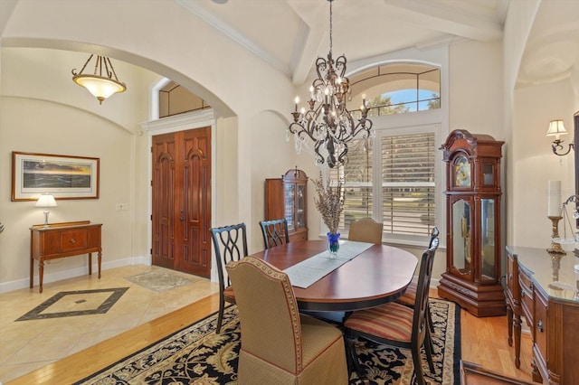 dining room with beamed ceiling and an inviting chandelier