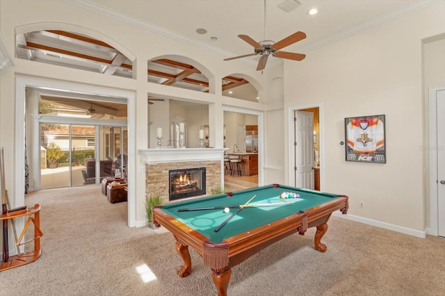 rec room with ceiling fan, light colored carpet, a fireplace, and crown molding