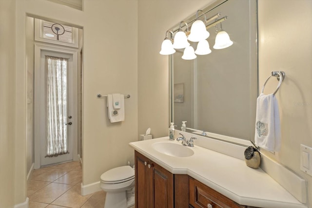 bathroom with toilet, tile patterned flooring, plenty of natural light, and vanity